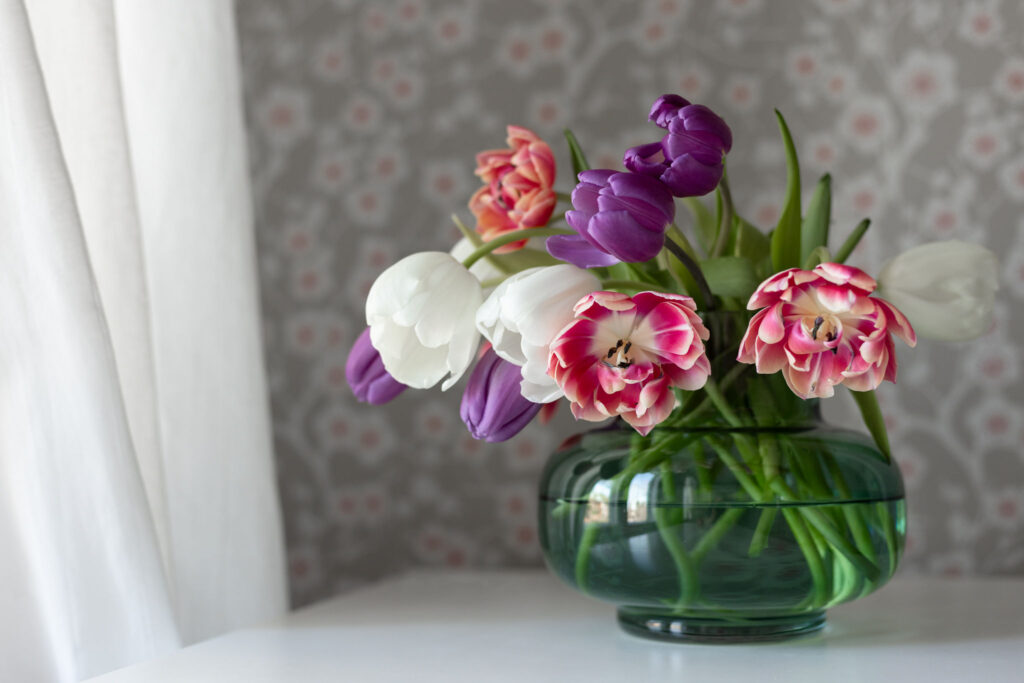 Kuva: kauniit tulppaanit pyöreässä vaasissa.