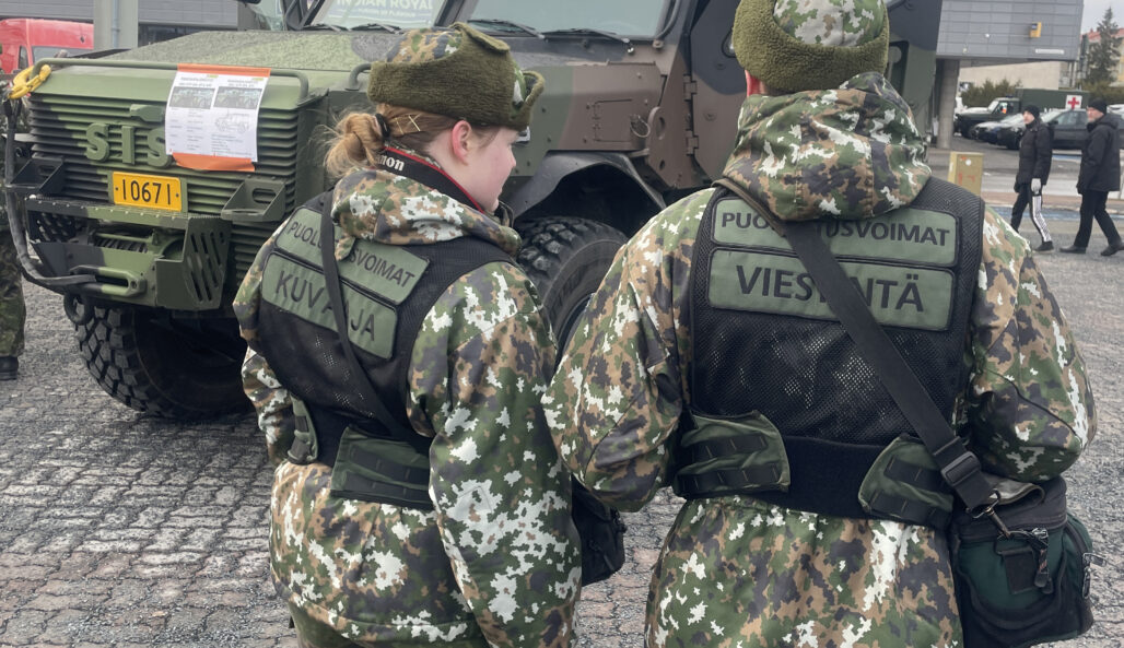 Two communications officers from the Pori Brigade in front of the SISU GTP tactical vehicle